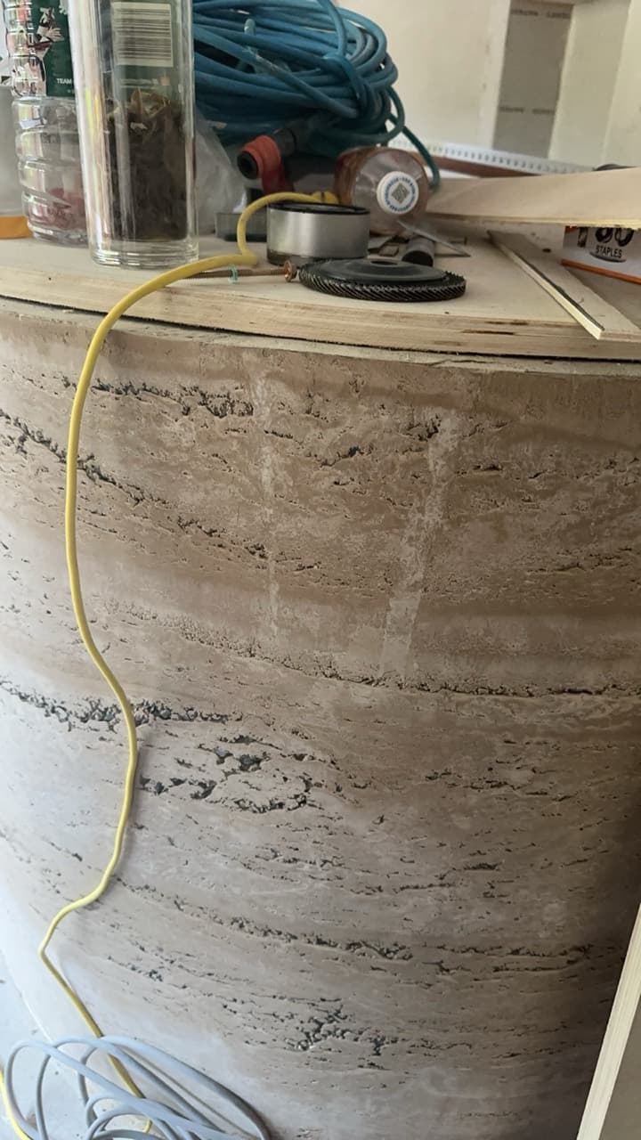 拆模以后的弧形吧台侧面,一层层的纹理,上面放着打磨工具